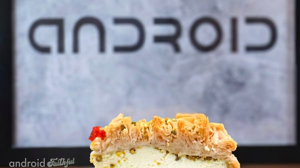 A photo of a slice of Baklava cheesecake in front of a poster that says the word Android. Credits: Mishaal Rahman.